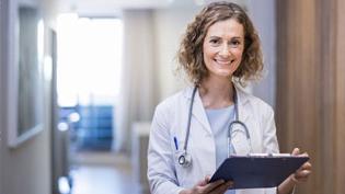 Female doctor reviewing patient chart.