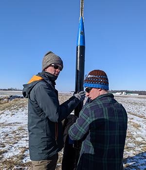 Mechanical 工程 seniors Forrest Putnam and Chad Sanderson prepare the subscale rocket for launch