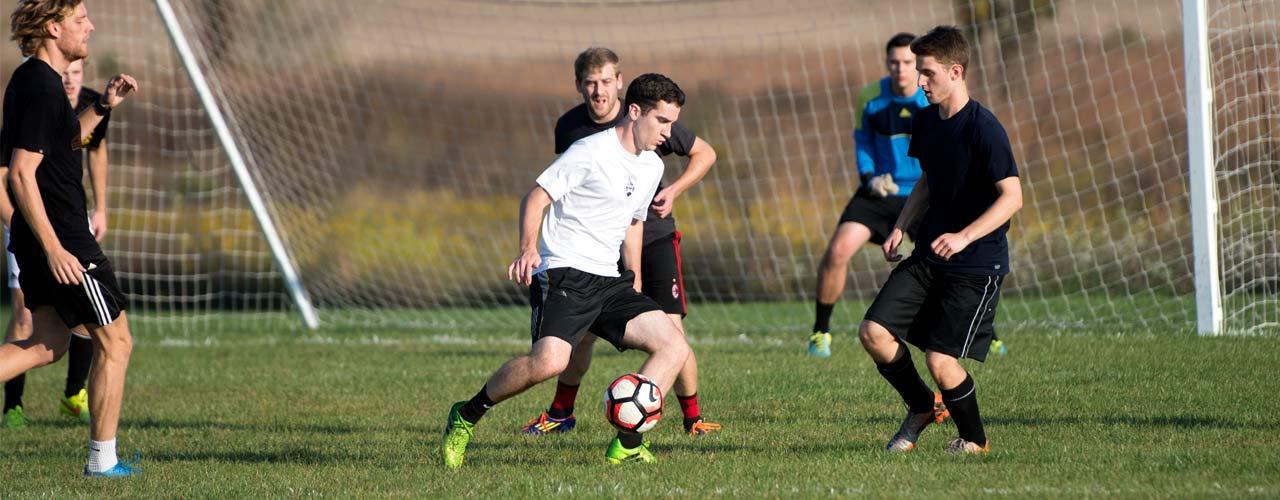 An intramural soccer team plays in a field