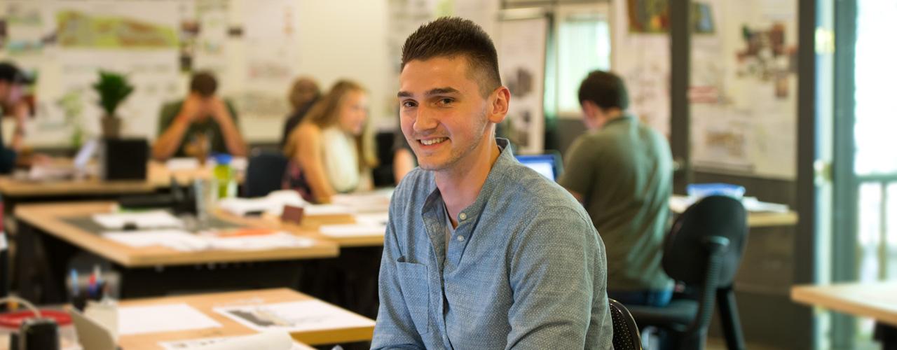 Male student smiles at camera