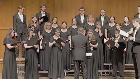 Group of singers performing with songbooks