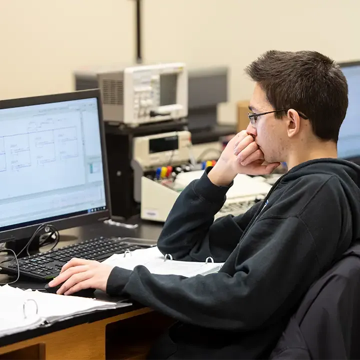 Man staring at computer screen.